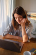 © ZHPH Production/Stocksy - Woman working on laptop from home online payment
