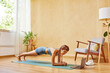 © ALTO IMAGES/Stocksy - Young sportswoman doing plank near laptop