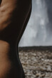 © Anastasia Mihaylova (Shpara)/Stocksy - Close-up naked woman's back by the waterfall in Iceland
