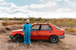 © Ezequiel Giménez/Stocksy - Senior man standing near car on vineyard