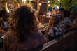 © Jovo Jovanovic/Stocksy - Group of friends enjoying dinner at outdoor tropical restaurant