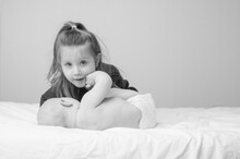 Black And White Portrait Of Toddler Girl With Her Sibling Baby Brother