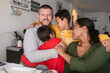 © ByLorena/Stocksy - Diverse Family hugging together at home