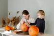 © Sergey Narevskih/Stocksy - Mother and daughter preparing pumpkin for Halloween holiday