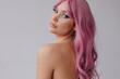 © Liliya Rodnikova/Stocksy - Beautiful woman with pink hair looking at camera