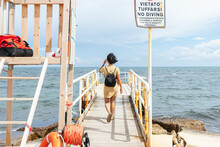 Young Woman Exploring Waterfront Dock