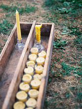 Close Up Of And Old Wooden Crate With Yellow Beeswax Candles Inside