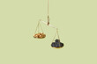 © Yaroslav Danylchenko/Stocksy - Golden nuggets and black coal weighted on scales.