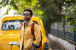 © Dream Lover/Stocksy - Portrait of an Indian man wearing yellow denim jacket at outdoors