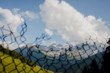 Mountain Landscape Through Broken Chain Link Fence