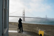 © Serena Burroughs/Stocksy - Father with a stroller walking toward the Golden Gate Bridge