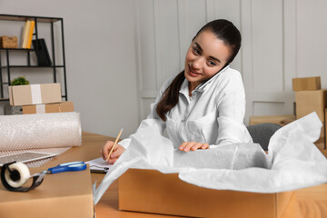 Poster - Seller talking on phone while working in office. Online store