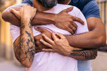 Close-up Of The Hands And Arms Of A Multiracial Gay Couple
