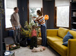 © Irina Ozhigova/Stocksy - Family   decorating Christmas tree