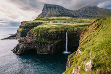 Water Cascade Falling Into The Sea In Faroe Islands