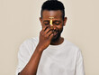 © ohlamour studio/Stocksy - Smiling man using t-shape roller