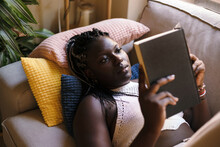 Black Woman Reading A Book At Home