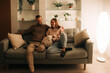 © Olga Moreira/Stocksy - Couple relaxing on a couch at night