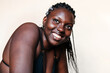 © Lucas Ottone/Stocksy - Close up portrait of smiling black woman