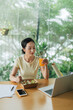 © Marc Tran/Stocksy - Young business woman has a healthy lunch at office desk