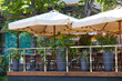 Restaurant terrace umbrella with light lamp bulbs. Modern exterior of summer cafe. Blurred image, selective focus