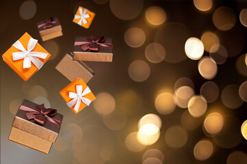 Wall Mural - gift boxes on brown background with bokeh. levitation