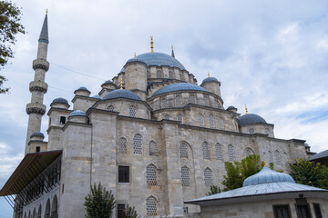 Wall Mural - The New Mosque and later New Valide Sultan Mosque photo on a cloudy day. Selective focus