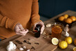 Sick woman preparing syrup for flu at autumn season
