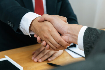 Wall Mural - Partnership. two business man investor handshake deal with partner after finishing up business meeting in meeting room office, partner, financial, teamwork, job interview, contract agreement concept