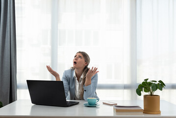 Young woman shouting trying to not to hear the loud noise from neighbor apartment in building while they renovate home and she cant work on laptop or study for college exam because of the noise