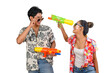 Portrait Young couple enjoy with water gun on Songkran festival