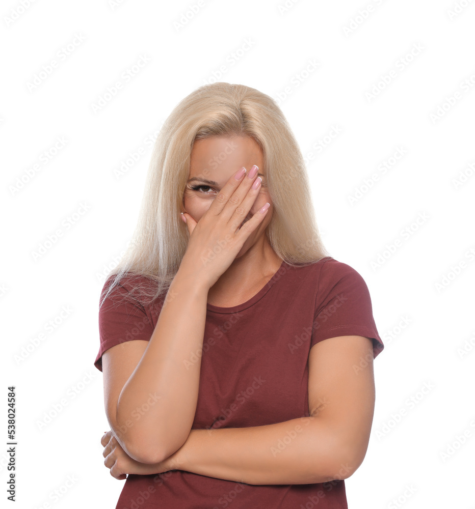 Embarrassed woman covering face with hand on white background Stock ...