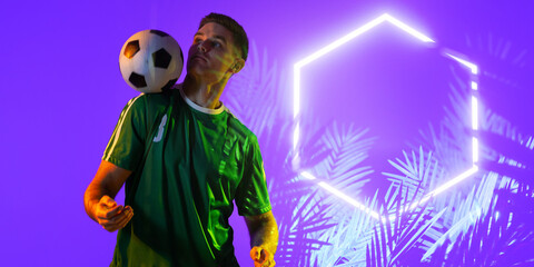 Wall Mural - Caucasian player balancing ball on shoulder by illuminated plants and hexagon on purple background