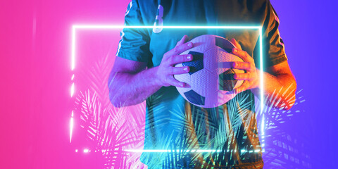 Canvas Print - Midsection of caucasian male player holding ball over illuminated plants and rectangle, copy space