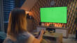 © Framestock - Woman switching channels with remote control. Couple sitting on sofa in living room, talking, watching breaking news, movie or series on TV. Resting at home at night. Green screen. Chromakey.