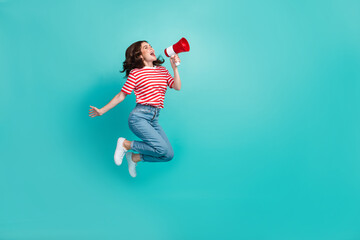 Sticker - Full length photo of pretty cute girl dressed red t-shirt jumping high shouting bullhorn empty space isolated teal color background