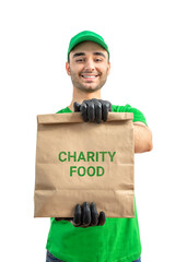 Wall Mural - Free Food Distribution. Volunteer carrying food donation box. Young smiling man wearing uniform cap and t-shirt, gloves holds out grocery set for in-need people. White isolated background