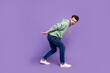 Full body photo of attractive young man carry look suspicious empty space dressed stylish khaki garment isolated on purple color background