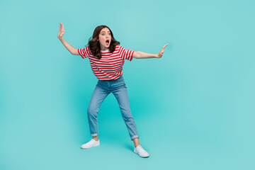 Wall Mural - Full length photo of shiny excited girl dressed red t-shirt surfing looking empty space isolated teal color background