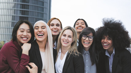 Multiracial group of business people having fun after meeting outside the office - Focus on center girl face