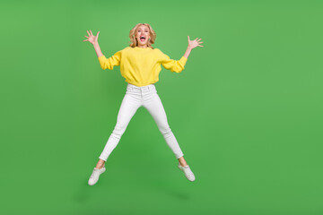 Sticker - Photo of shiny excited lady dressed yellow pullover jumping high like star empty space isolated green color background