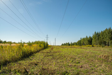 Wall Mural - Power line towers. Out-of-town power supply system. Energy infrastructure in the fields in the countryside.