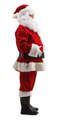 Sticker - Full length profile shot of santa claus standing and holding his belly