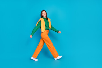 Wall Mural - Full length profile portrait of stunning satisfied person walking toothy smile isolated on blue color background