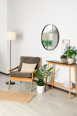 Wall Mural - Stylish living room interior with wooden furniture, houseplants and round mirror on white wall