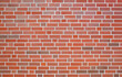 Wall made of red bricks and light gray joints, background image