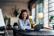 © bnenin - Portrait of a smiling businesswoman, holding her hands crossed, sitting at the office.