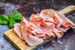 Slices Of  Traditional Italian antipasti mortadella Bolognese  on a wooden  cutting board.