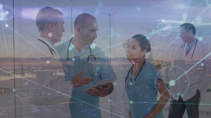 Sticker - Animation of connected dots, aerial view of city, multiracial doctors discussing over tablet