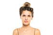 © vladimirfloyd - woman with messy loose bun and no makeup on a white studio background. front view